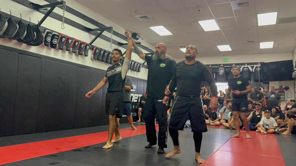 C3 student with hand raised in victory in front of a cheering crowd